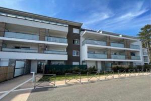a large apartment building with a lot of windows at Studio Leman Ciel avec parking privé gratuit in Gex