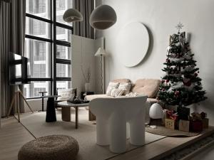 a living room with a christmas tree and a couch at Cozy Ins Duplex EkoCheras 1-6pax in Kuala Lumpur