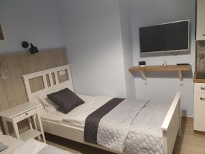 Łóżko lub łóżka w pokoju w obiekcie Willa Idylla