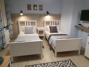 Łóżko lub łóżka w pokoju w obiekcie Willa Idylla