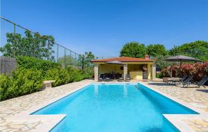 a swimming pool in a yard with a house at 3 Bedroom Amazing Home In Smoljanci in Smoljanci