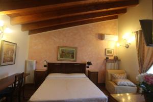 a bedroom with a bed and a table and a couch at Casa San Marco in Castelnuovo del Garda +131 photos