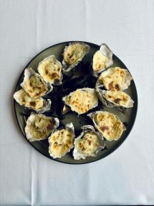 a plate of oysters sitting on a table at La Cremaillere Hôtel-Restaurant in Courseulles-sur-Mer