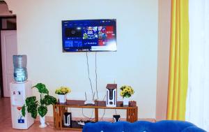 a living room with a tv on the wall at Bamburi Luxury Homes III One bedroom apartment in Bamburi