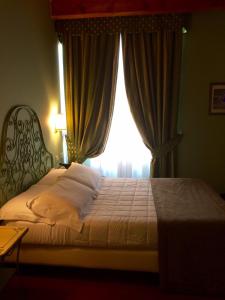 Ένα ή περισσότερα κρεβάτια σε δωμάτιο στο Hotel Borgo Antico