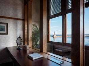 an office with a desk with a view of the ocean at Domus Renier Boutique Hotel in Chania Town