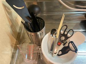 a container of utensils on a counter next to a glass at ura 東横のヨコ301 in Kaigandōri +21 photos