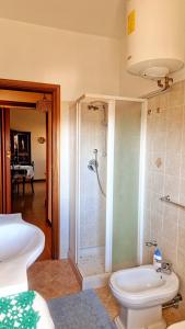 a bathroom with a shower and a toilet at La perla sul Tirreno in Briatico +34 photos