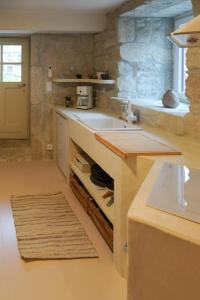 a kitchen with a sink and a counter top at Charming Douro Valley Stone Home in Coura