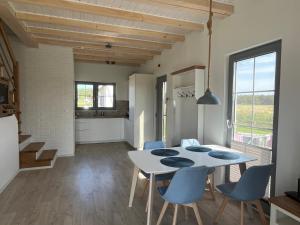 a kitchen and dining room with a table and chairs at Słowiński Horyzont in Rowy