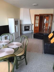 a living room with two tables and a couch at Piso Beiramar O Grove in O Grove +4 photos