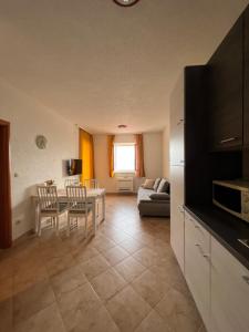 a kitchen and living room with a table and chairs at Villa Marina Bol in Bol