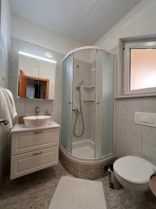 a bathroom with a shower and a toilet and a sink at Villa Marina Bol in Bol +23 photos
