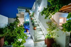 a staircase in a house with potted plants at Kontaratos Studios & Apartments in Parikia +230 photos