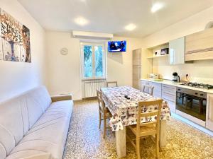 a living room with a couch and a table at GRAMSCI HOUSE - Anzio Centro in Anzio