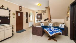 a living room with a couch and a table at Sun Village Domki in Stegna