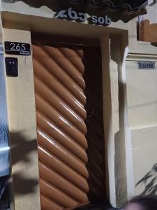 a wooden door with brown blinds on a building at Quarto Suite na Gavea in Rio de Janeiro