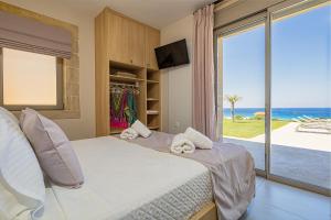 a bedroom with a bed with a view of the ocean at Alki Villas Collection -Luxury Sea View Villas -Breakfast Included-Falasarna in Falasarna +143 photos