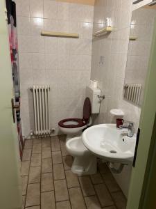 a bathroom with a toilet and a sink at Naviglio 34 in Parma