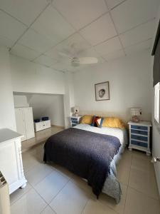a bedroom with a bed in a white room at El cobijo in Granada