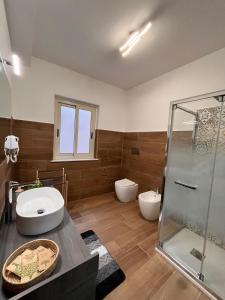 a bathroom with two toilets and a glass shower at Levante in Augusta