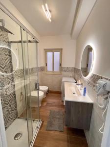 a bathroom with a shower and a sink and a toilet at Levante in Augusta +9 photos