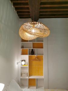 a chandelier hanging from a ceiling in a room at La manufacture royale de la bonde Chambre 1 in Cuxac-Cabardès