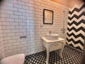 a white bathroom with a sink and a mirror at Just Home in Varna City +42 photos