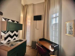 a kitchen with a sink and a desk next to a window at Just Home in Varna City
