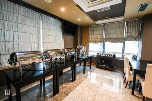 a dining room with a long table with chairs at Hotel Arifi in Shkodër