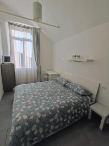Postel nebo postele na pokoji v ubytování Villa Antonella, app. Vittoria