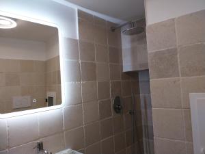 a bathroom with a mirror and a shower at Casa Antonietta - Ostuni Centro in Ostuni +14 photos