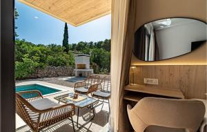 a room with a view of a pool and a tv at 3 Bedroom Nice Home In Prizba in Prizba