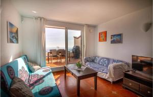 a living room with a couch and a tv at Cozy Apartment In Cumbre Del Sol in Cumbre del Sol