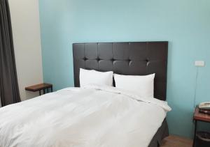 Ένα ή περισσότερα κρεβάτια σε δωμάτιο στο Happy Guesthouse