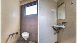 a bathroom with a toilet and a sink and a mirror at Hotel Neelam in Amravati +30 photos