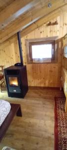 a room with a woodburning stove in a cabin at Casa Umberna in Asiago