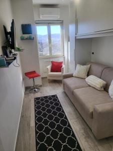a living room with a couch and a chair at Casa Vacanze Panoramica in Bagnoli del Trigno