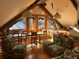 a living room with a table and chairs at La Grangia - mountain loft in Rollieres