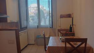 a kitchen with a table and two chairs and a window at Casa David in Cava deʼ Tirreni
