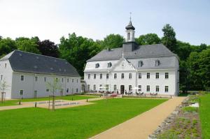 a large white building with a tower on top at Hotel Schloss Rabenstein in Chemnitz