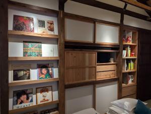a room with a book shelf with books at 弎秋 A chu in Chiayi City