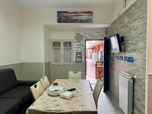 a dining room with a table and a couch at Casa Alma in Naples