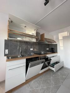a kitchen with white cabinets and a sink at Ferienhaus - Eifeltraum - Salm in Salm +17 photos