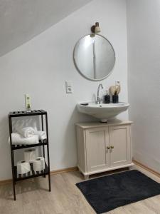 a bathroom with a sink and a mirror on the wall at Ferienhaus - Eifeltraum - Salm in Salm