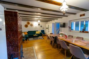 a dining room and living room with a table and chairs at Teodor Chalet - Valea Avrigului in Avrig