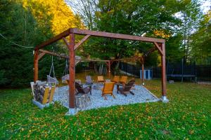 a gazebo with chairs and tables in a yard at Teodor Chalet - Valea Avrigului in Avrig