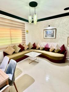 a living room with a large couch with pillows at Apartment, well equipped in Fez