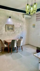 a dining room with a wooden table and chairs at Apartment, well equipped in Fez