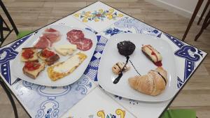 two plates with different types of food on a table at B&B DieMme Amalfi Coast in Vietri sul Mare